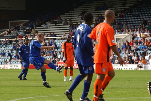 Neil Wood (left) scores for Posh against Colchester United in 2003.