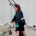 Claire Cottingham pushing her son Stefan in a pram outside Woolworths with step-son Joeboy pulling a trolley with her daughter, Nicole, on it