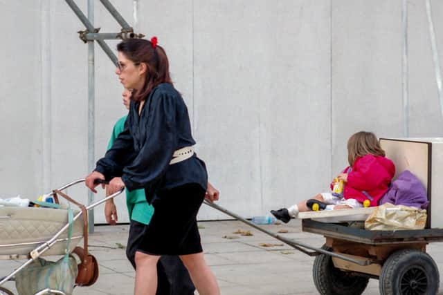 Claire Cottingham pushing her son Stefan in a pram outside Woolworths with step-son Joeboy pulling a trolley with her daughter, Nicole, on it