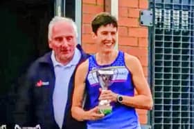 Captain Claire Smith with the Eastern Masters Track and Field League trophy.