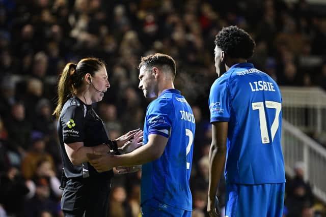 Posh skipper Carl Johnston with match referee Abigail Byrne. Photo David Lowndes.