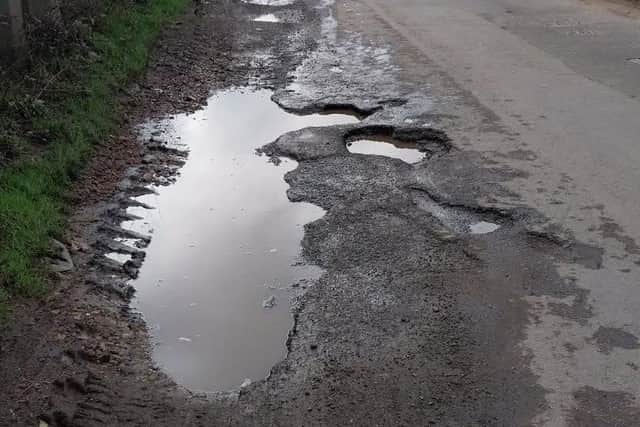 Images from the North Brink, near Wisbech show potholes tagged for repairs by Cambridgeshire County Council.
