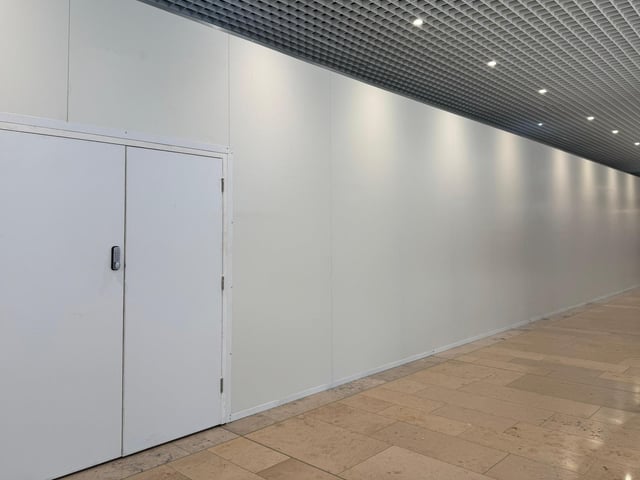The new hoardings that show work is under way to creating  install the fixtures and fittings  required by retail giant Frasers as it prepares to move into the Queensgate Shopping Centre in Peterborough