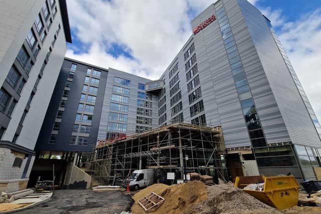 A decision to sell the partly-built Hilton Garden Inn, Peterborough, will be challenged today