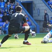 Posh man of the match Josh Knight slides after a through ball during the game against Orient. Photo: David Lowndes.