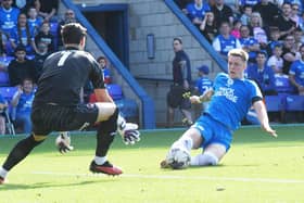 Posh man of the match Josh Knight slides after a through ball during the game against Orient. Photo: David Lowndes.