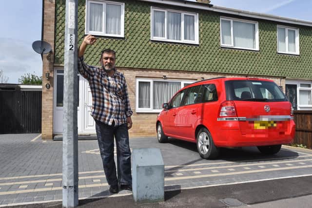 Hasnain Tejani with lamp post outside his house at Fawsley Garth, Westwood