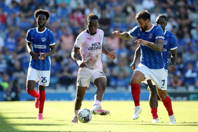 Peter Kioso of Peterborough United in action with Marlon Pack of Portsmouth. Photo: Joe Dent/theposh.com