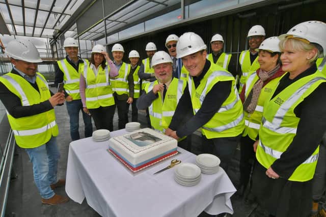 Cutting the cake at the topping out ceremony at the Hilton Hotel, Fletton Quays.