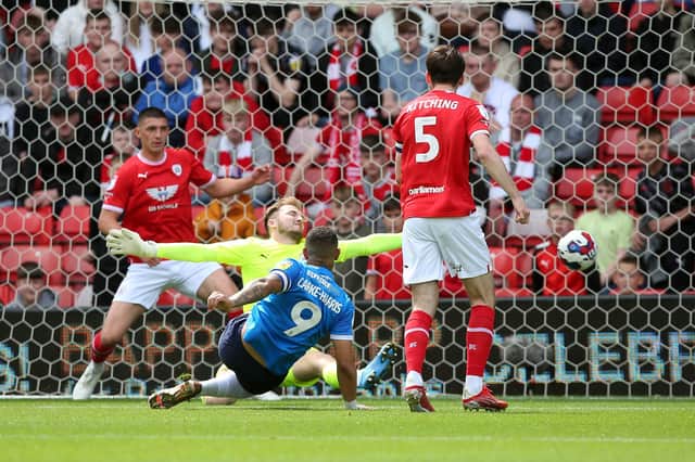 Jonson Clarke-Harris of Peterborough United scores the opening goal of the game against Barnsley. Photo: Joe Dent.