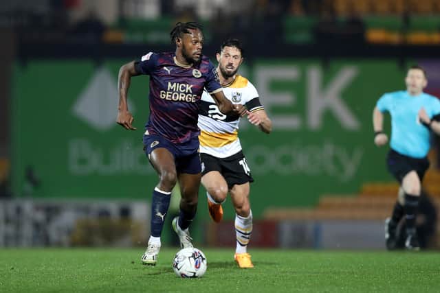 Ricky-Jade Jones of Peterborough United in action with Jason Lowe of Port Vale. Photo: Joe Dent.