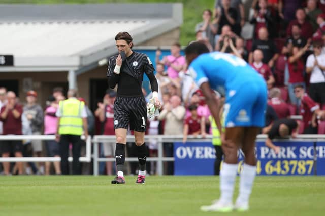 Nicholas Bilokapic of Peterborough United looks dejected at full-time following defeat at Northampton. Photo: Joe Dent.