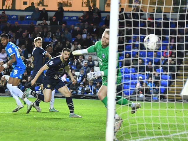 Port Vale defender Alex Lacovitti heads into his own goal to complete a 3-0 defeat at Posh. Posh substitute Malik Mothersille is in attendance. Photo David Lowndes.