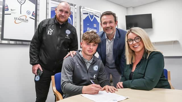 Gabe Overton signs his professional development contract at Posh.