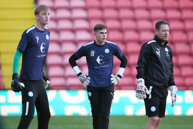 Will Blackmore (centre) of Peterborough United warming up ahead of his first league start for the club alongside Lucas Bergstrom (left) and Goalkeeper Coach Mark Tyler (right). Photo: Joe Dent/theposh.com.