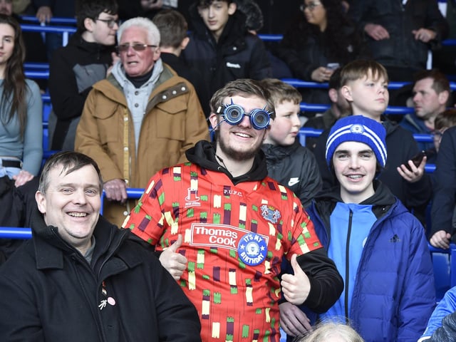Peterborough United fans are pictured watching the crucial win over Derby County.