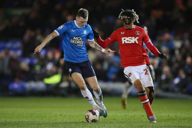 Jack Taylor of Peterborough United in action with Sean Clare of Charlton Athletic. Photo: Joe Dent/theposh.com.