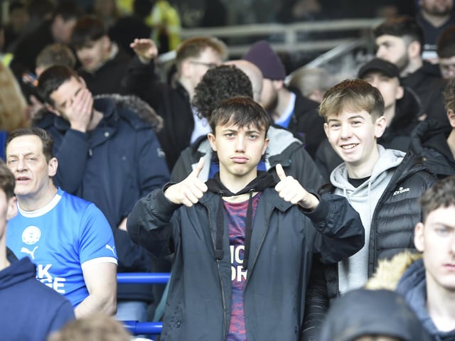 Peterborough United fans watch as their side slip to defeat against Blackpool.
