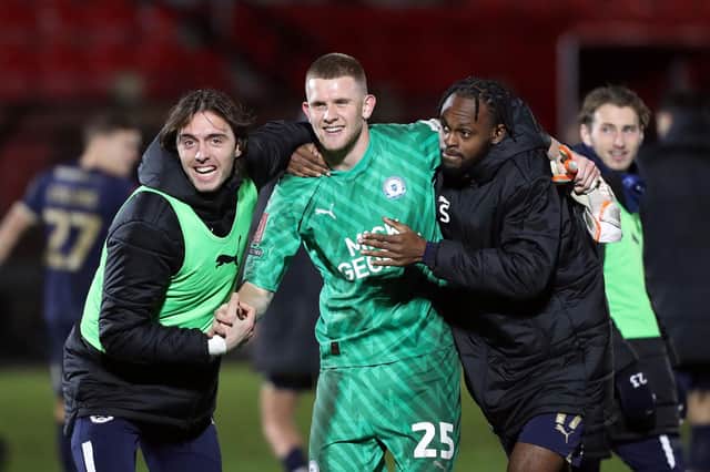 Fynn Talley of Peterborough United celebrates at full-time with his teammates. Photo: Joe Dent.