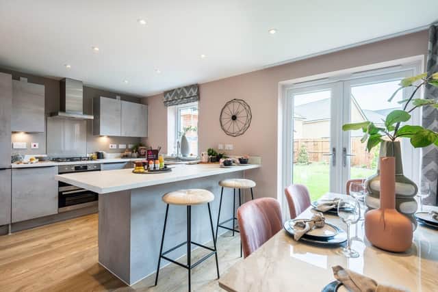 B&amp;DWC - AH9_1627 A - The open-plan kitchen and dining area inside the Chester show home at Hampton B