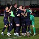 Peterborough United players celebrate winning the penalty shoot-out. Photo: Joe Dent.