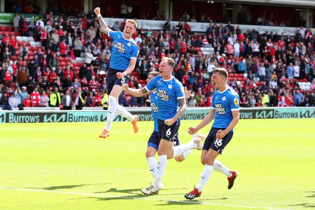 Josh Knight, Frankie Kent and Harrison Burrows jump for joy after the final whistle. Photo: Joe Dent.