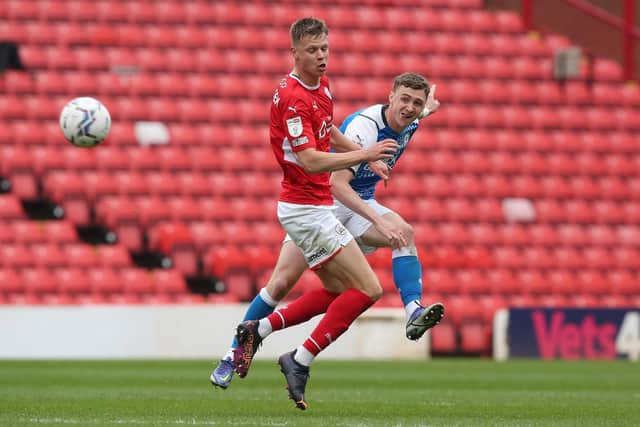 Jack Taylor (blue) in action for Posh.
