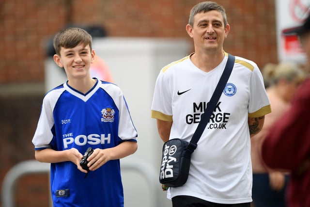 Two Posh fans make their way to London Road.