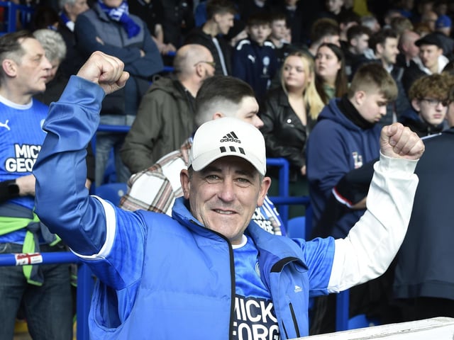 Peterborough United fans are pictured watching the crucial win over Derby County.