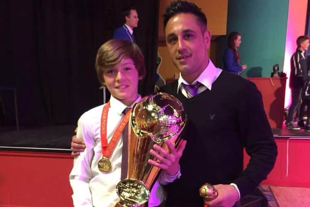 Harrison with John Rowe collecting another trophy