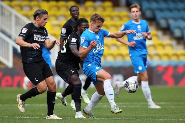Archie Collins of Peterborough United in action with George Dobson of Charlton Athletic. Photo: Joe Dent/theposh.com.