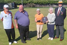 Sherin Noble and Norma Squires are pictured with the Malcolm Squires and Dick Noble Shield alongside (from the left) Adams captain Ray Keating, Hunts manager Bob Morton and Northants president Martyn Dolby.