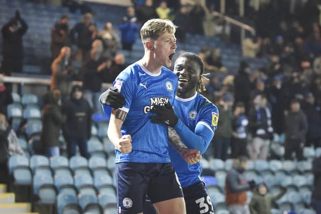 Frankie Kent celebrates his winning goal for Posh against Shrewsbury with teammate Kabongo Tshimanga. Photo: David Lowndes.