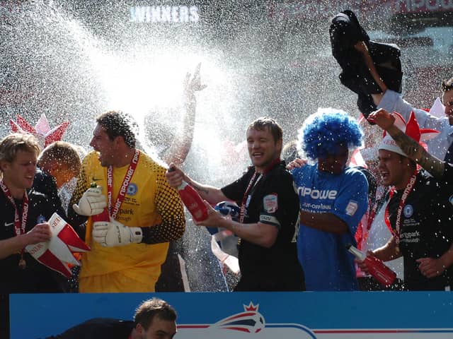 Goalkeeper Paul Jones (yellow jersey) celebrates a promotion with Posh at Old Trafford alongside current London Road boss Grant McCann. Photo: David Lowndes.