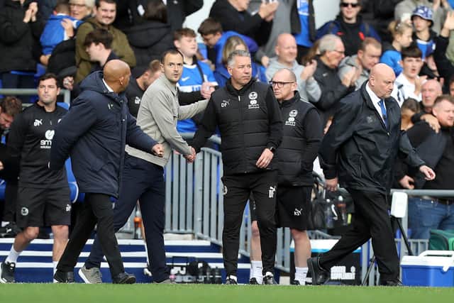 Manager Darren Ferguson shakes hands with Birmingham City Manager Chris Davies. Photo: Joe Dent.