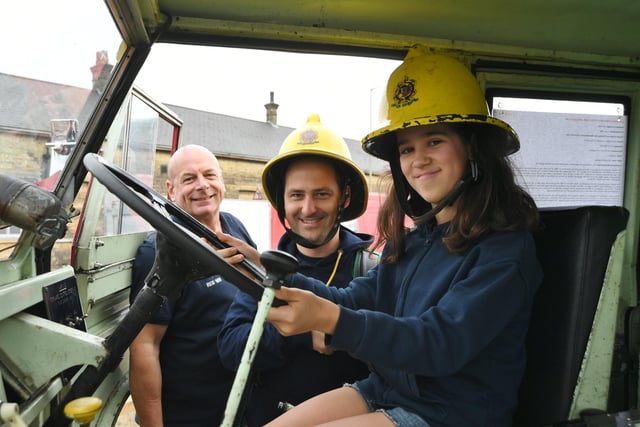 Hon Leading firefighter Adrian Thompson and his vintage fire appliance with Natalia and Alexandru Ionescu.