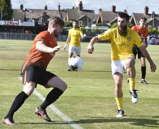 Peterborough Sports player-manager Michael Gash (orange) in action. Photo: David Lowndes.
