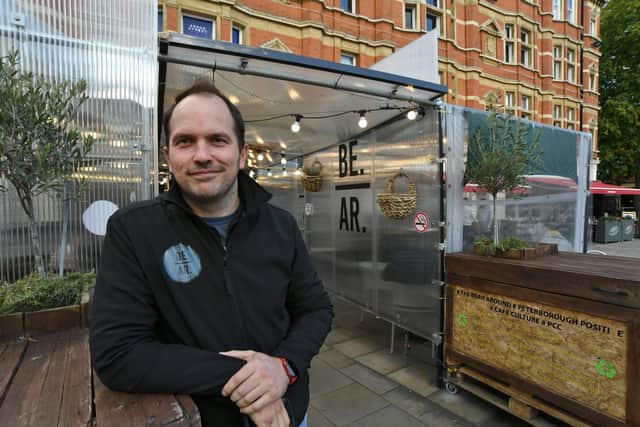 Gareth Norman with his outside seating area at his Bean Around coffee bar at Cathedral Square