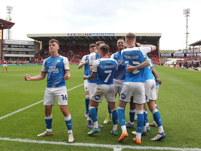 Harrison Burrows was one of those to pick up their form when Darren Ferguson returned as Posh manager in January, 2023. Here the youngster celebrates a goal in the crucial final day League One win at Barnsley which secured a play-off place.