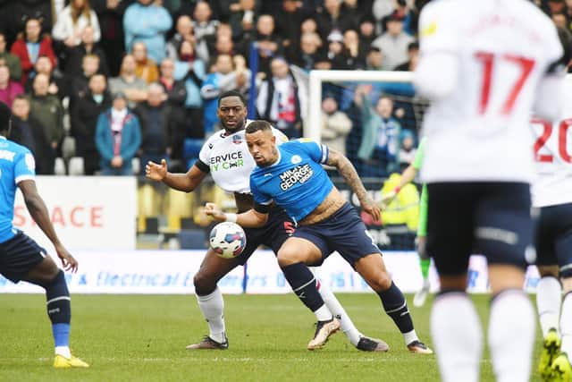 Ricardo Santos v Jonson Clarke-Harris during Posh v Bolton last season. Photo: David Lowndes.