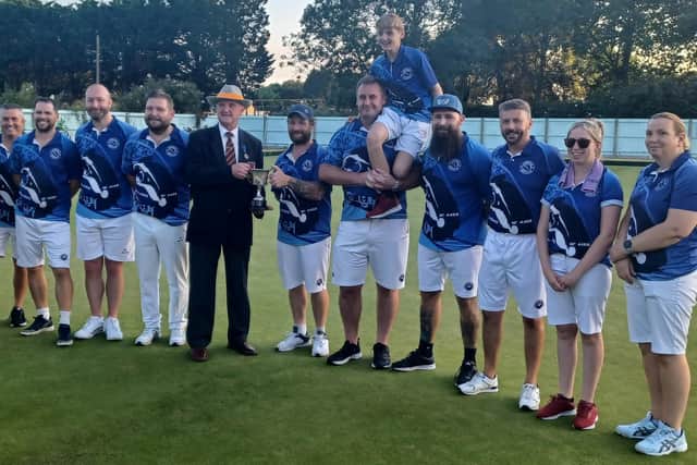 Parkway receive the Dan Duffy Cup from Martin Dolby, president of the Northants Bowls Federation.