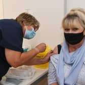 A new covid and flu vaccination campaign has been rolled out early in Peterborough amid fears of a 'twindemic' - topping up jabs given two years ago. Picture shows Monica Allen getting her booster jab at the then NHS vaccination centre in the Queensgate shopping centre in 2021.