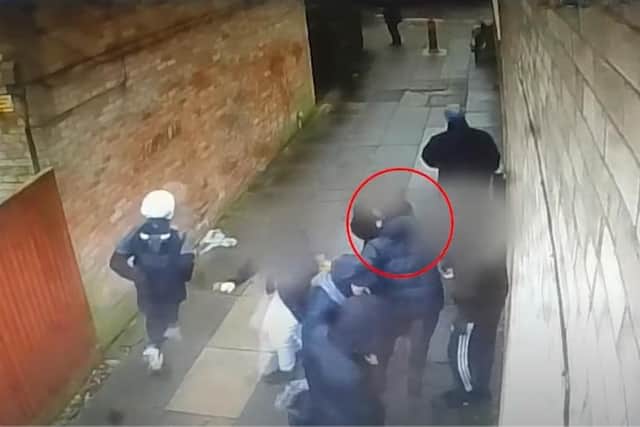 A still from CCTV in Eastwood showing what police call 'known drug users' in an alleyway.