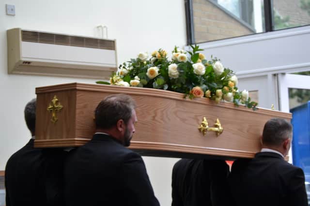 The coffin of Charles Swift is carried out of the Salvation Army Citadel.