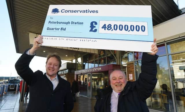 MP for Peterborough Paul Bristow and Council leader Wayne Fitzgerald with the Peterborough Station quarter regeneration cheque from the Government