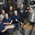 Wonky Donkey owners David and Andy Williams (centre) brewing their special 'Great Uncle Tom' beer for the Poppy Appeal.  Alongside them are Richard Matthews and Mick Lamb of Mile Tree Brewery, and Sandy and Malcolm Foster from the Royal British Legion.