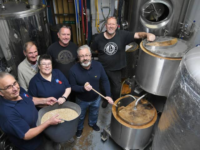Wonky Donkey owners David and Andy Williams (centre) brewing their special 'Great Uncle Tom' beer for the Poppy Appeal.  Alongside them are Richard Matthews and Mick Lamb of Mile Tree Brewery, and Sandy and Malcolm Foster from the Royal British Legion.