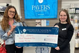 Pavers employee, Lisa Abel (r) presenting a cheque for £2,500 to Tiny Tickers.