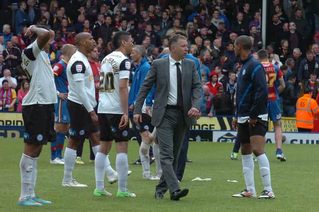 Posh boss Darren Ferguson and his players after relegation from the Championship was confirmed in 2103.