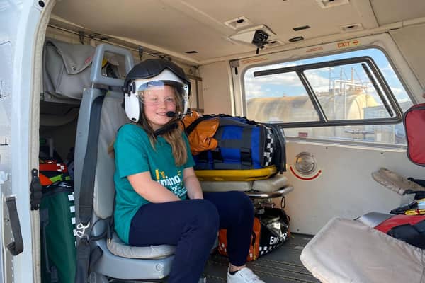 Hannah testing out the best seat in the house, inside the helicopter.
